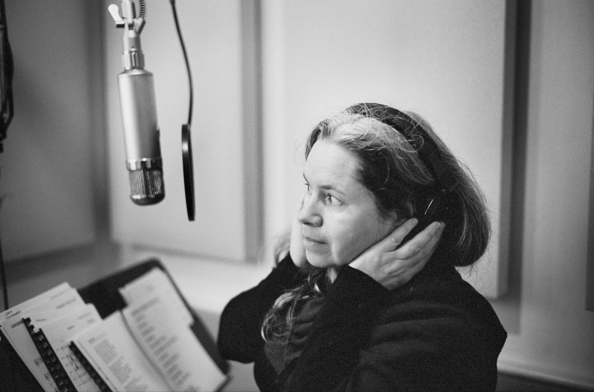 Black and white photo of Natalie Merchant wearing headphones