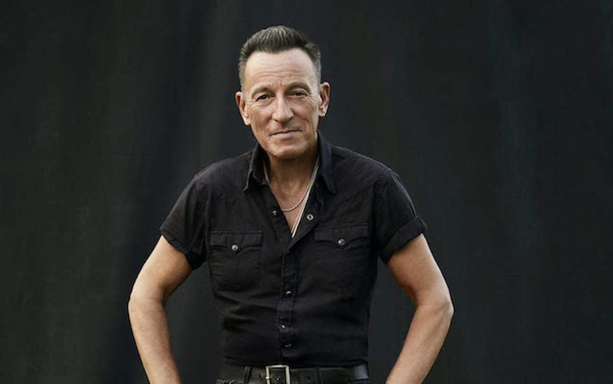 Bruce Springsteen sitting on stool for Only the Strong Survive