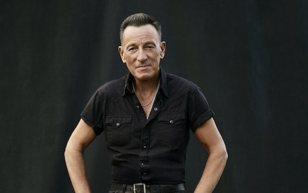 Bruce Springsteen sitting on stool for Only the Strong Survive