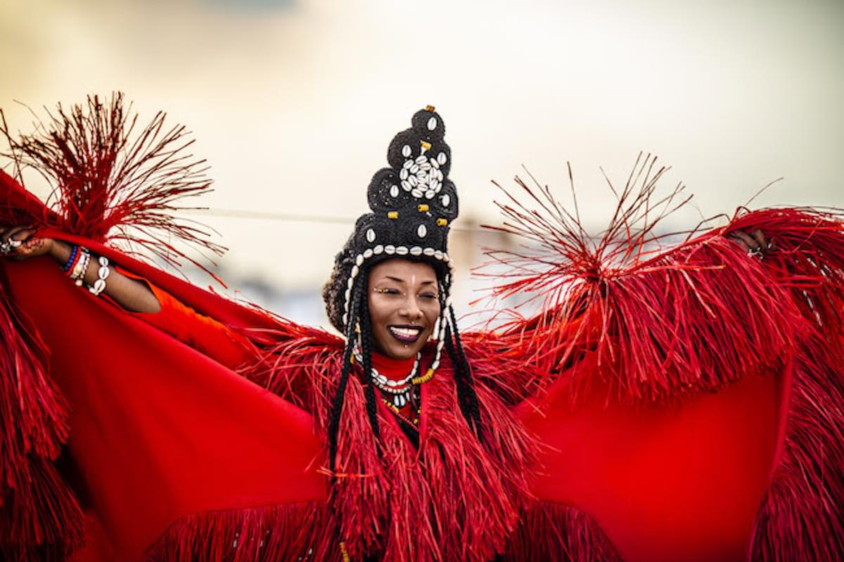 Fatoumata Diawara red tassel clothing black headdress