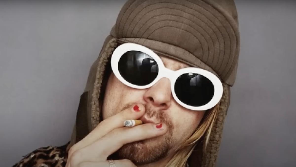 Kurt Cobain smoking with brown hat white sunglasses
