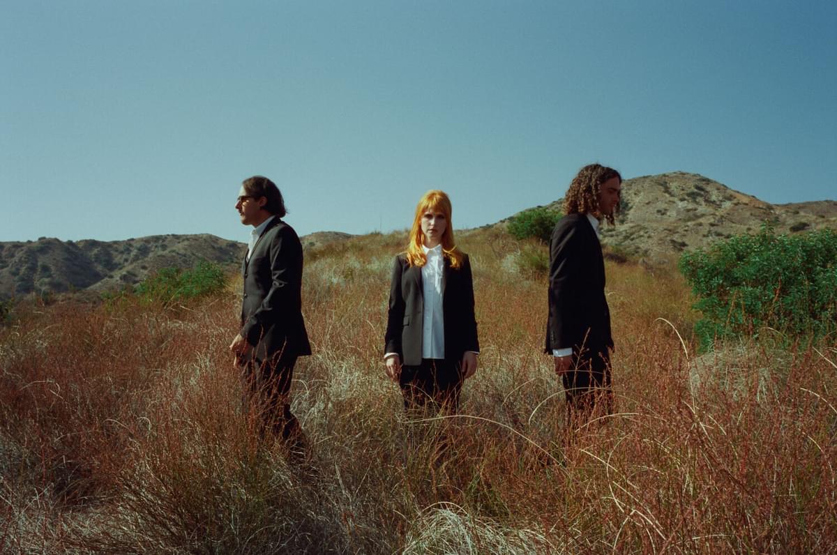 Paramore wearing suits in field