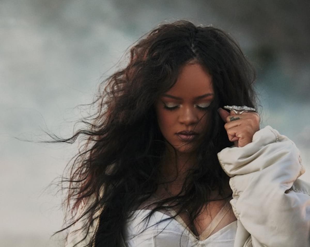 Rihanna looking down foggy background hair blowing in wind