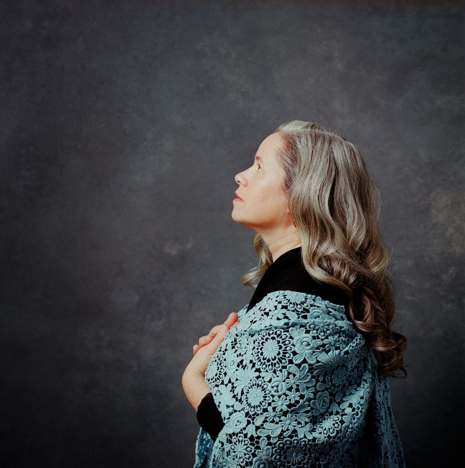 Side profile of Natalie Merchant wearing a shawl and looking up and to the left