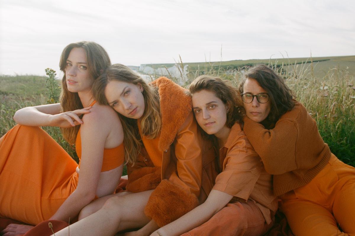 The Big Moon orange outfits in field for "This Love"