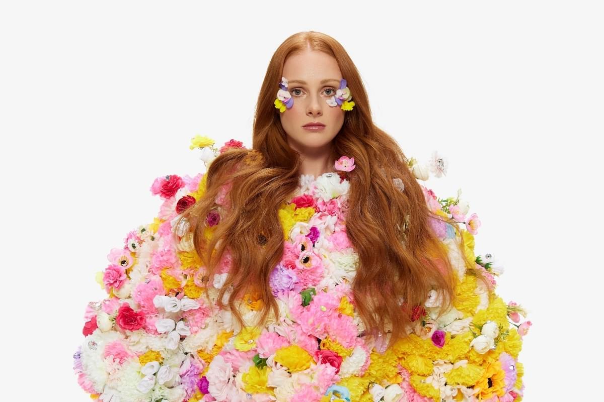 Vera Blue in outfit made out of flowers for "Mermaid Avenue" single