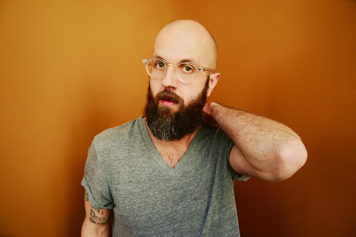 William Fitzsimmons YELLOW BACKGROUND GRAY SHIRT ARM BENT BEHIND HEAD PHOTO CRED SHERVIN LAINEZ High Rez v1