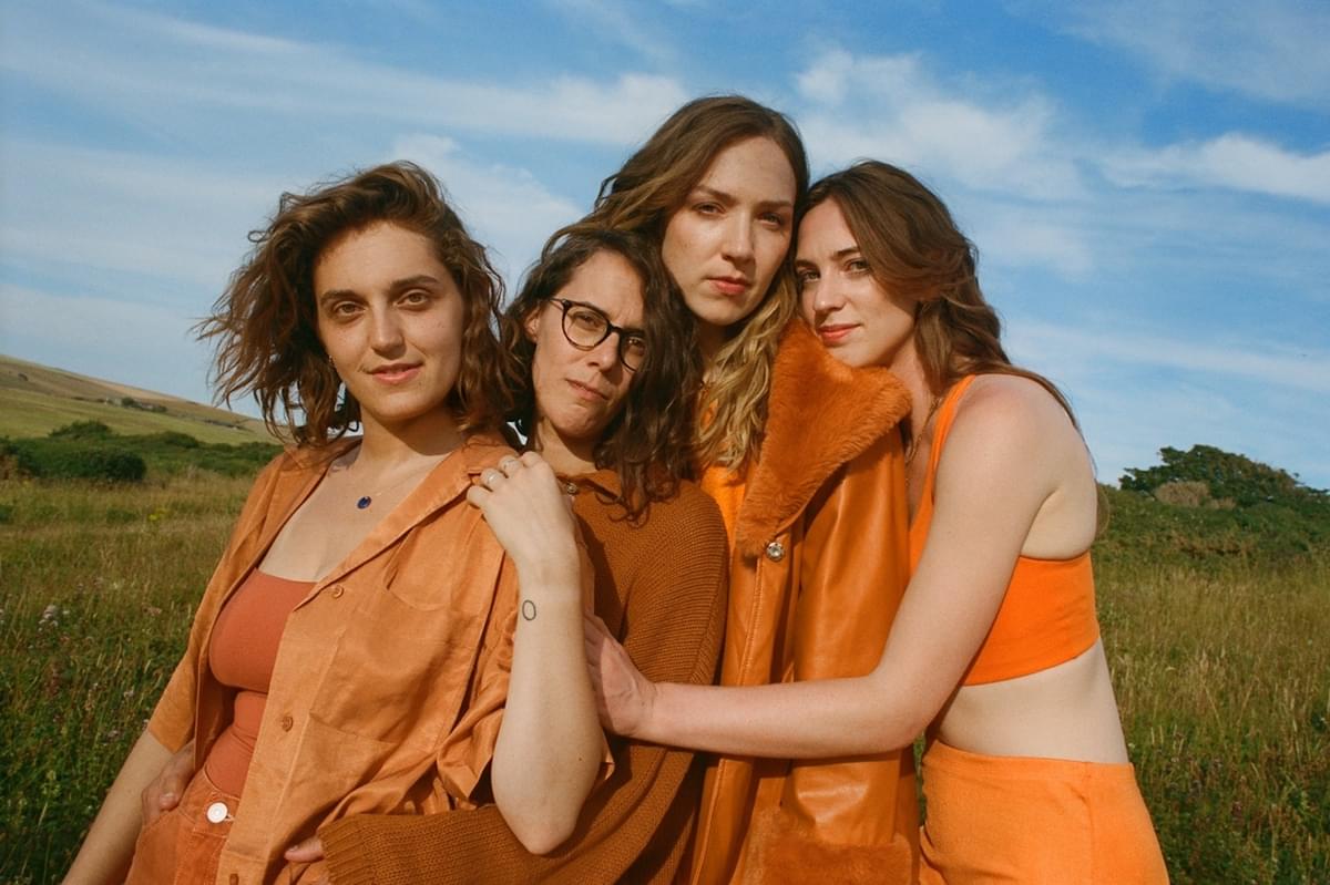 The Big Moon in a field dressed in orange for "Trouble" single